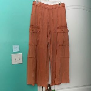 Peachy, orange pants with a drawstring and 2 large pockets on the side